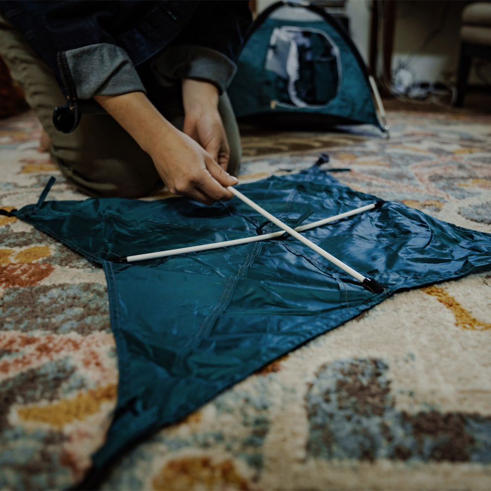 the rainfly for a Blue tiny tent being assembled.