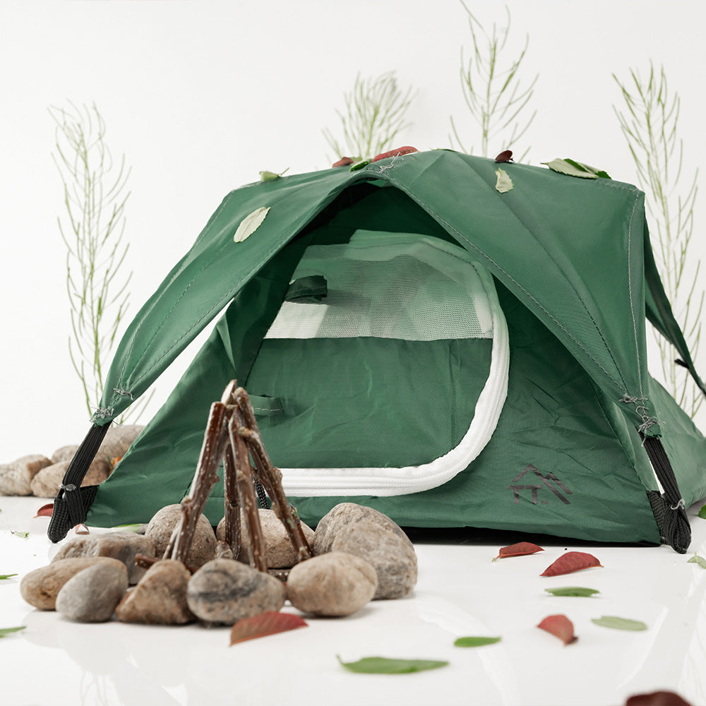 Alpine green micro tent set up in fake campfire studio scene